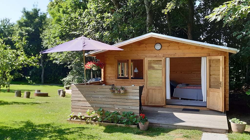 Agnes hytte i høj solskin om sommeren